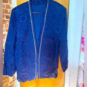 Unlabeled blue blazer with floral under pattern and white piping detail